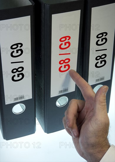 Hand pointing to a file folder labeled 'G8 - G9'