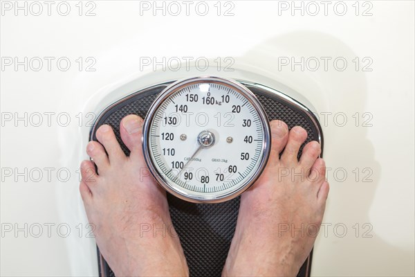 A man standing on bathroom scales