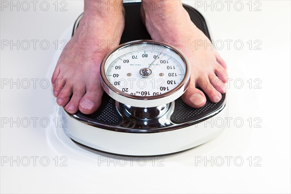 A man standing on bathroom scales