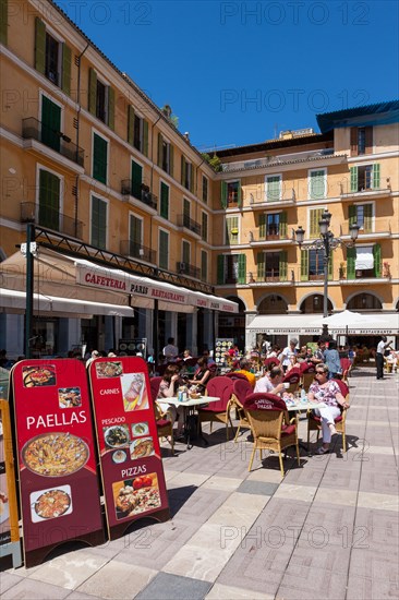 Central street cafes offering paella on Placa de Major square