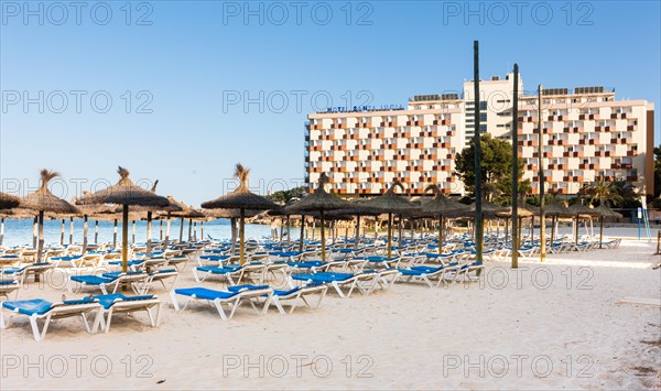 Section of beach near Palma Nova with sunbeds and hotels