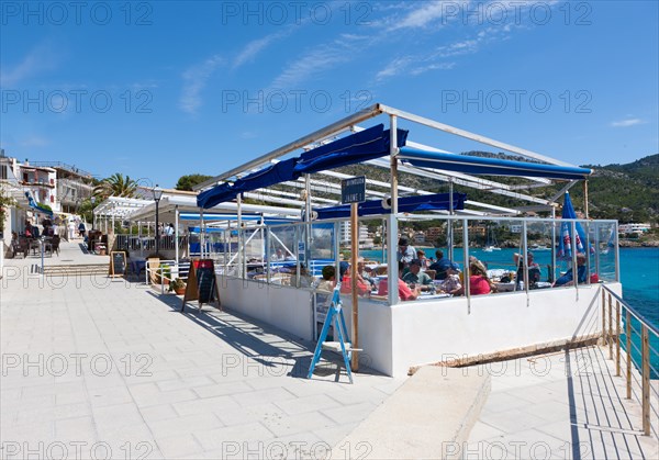 Outdoor restaurants with tourists in Sant Elm