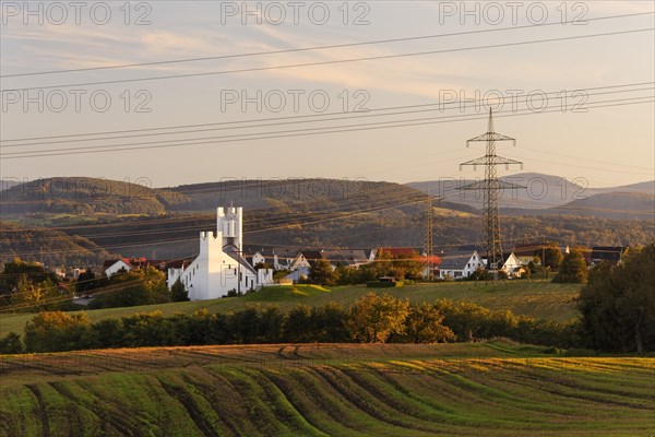 Church of St. Michael built in the early 1990s and power lines of the Hochrheinkraftwerke power plant