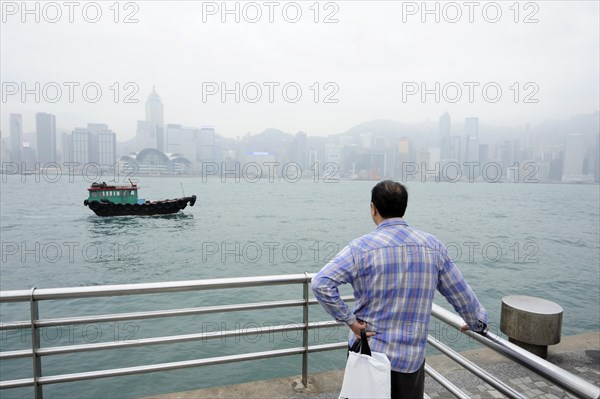 Man standing at the waterfront in Tsim Sha Tsui