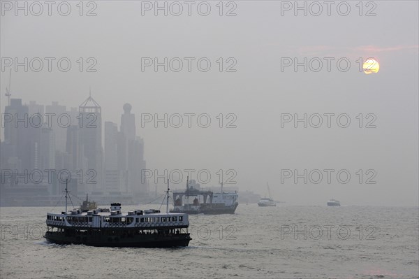 Boats in the bay of Victoria Harbour and Hong Kong Island in the evening