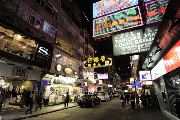 Neon signs on a street in Tsim Sha Tsui at night