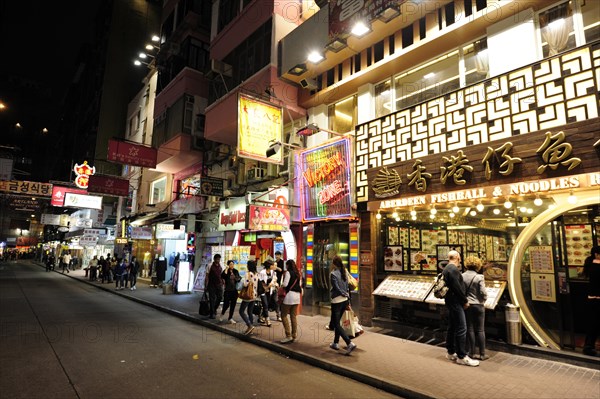 Shops on a street in Tsim Sha Tsui at night