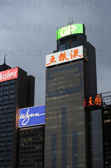 Skyscrapers and neon signs at dusk