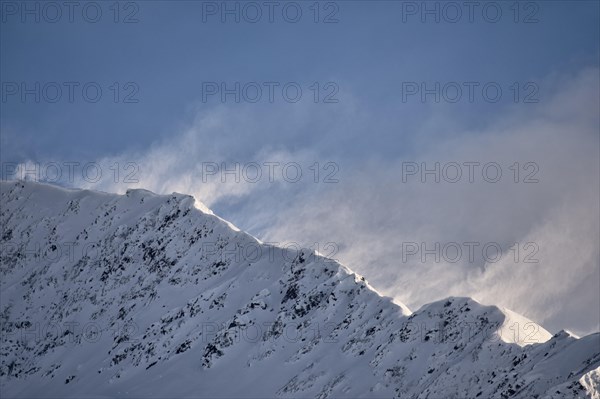 High winds blast a ridge in the Chugach Range