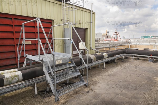 Steps giving access over roof top industrial plant pipework