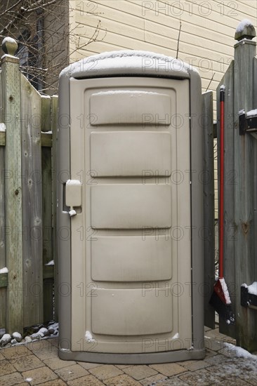 Small storage shed in a residential backyard in winter