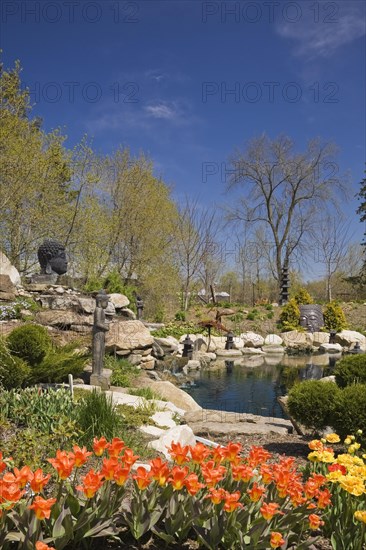 The ornamental pond in the Zen garden at springtime in the 'Route des Gerbes d'Angelica' garden in Mirabel
