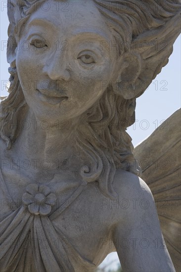 Close-up of a female like statue with wings in the Fairy garden at the 'Route des Gerbes d'Angelica' garden in Mirabel