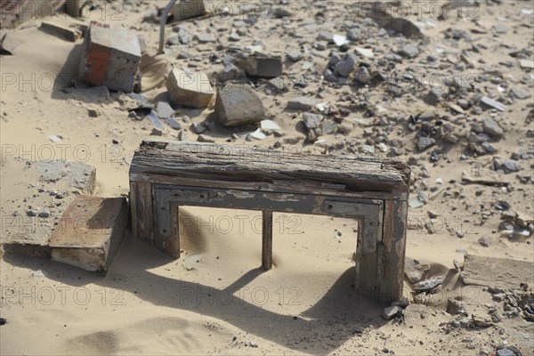 Window frame covered in sand of a stripped bare house on the Rubjerg Knude wandering dune