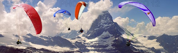 Paragliders over the Matterhorn mountain peak