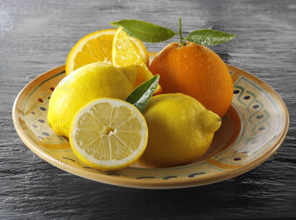 Fresh whole and cut oranges and lemons