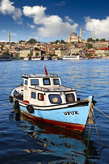 Fishing boat in the Golden Horn on the Galata banks looking towards the Suleymaniye Mosque