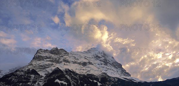 Sunset and clouds over the summit of the North Face of Eiger mountain