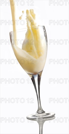 Fresh flavoured milk being poured into a glass