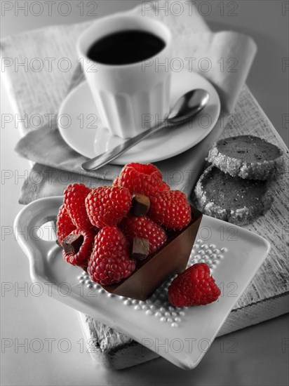 Chocolate cake filled with chocolate truffle and topped with fresh raspberries