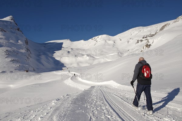 Walker in the snow in the mountains near Grindelwald First