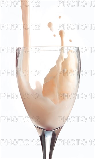 Fresh flavoured milk being poured into a glass