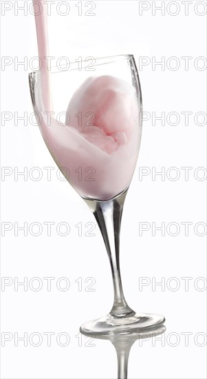 Fresh flavoured milk being poured into a glass