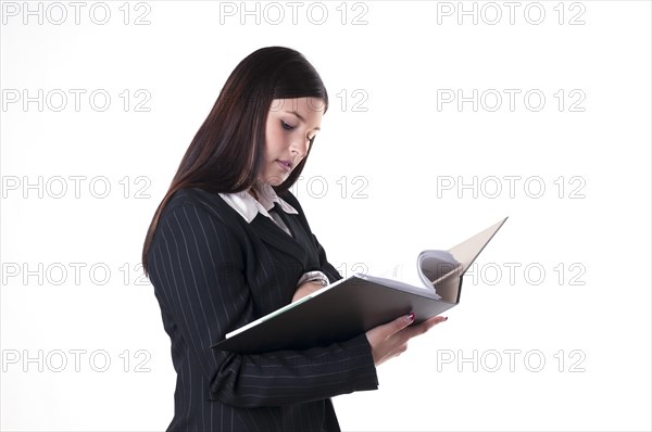 Businesswoman reading documents in a folder