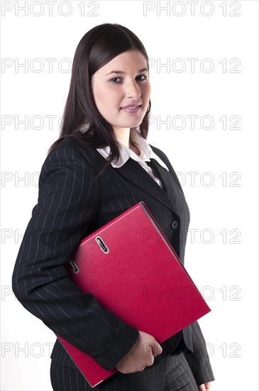 Businesswoman holding a red folder in her arm