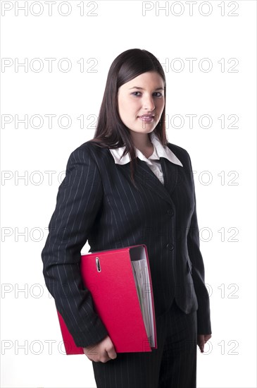 Businesswoman holding a red folder under her arm