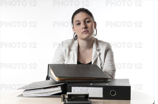 Office worker sitting at a desk with files