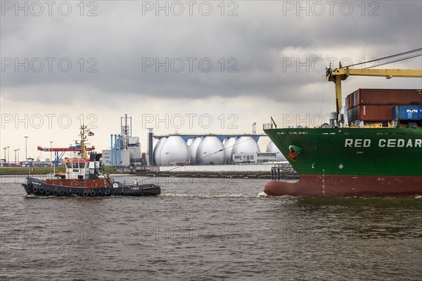 Tug boat towing a container ship on the Elbe