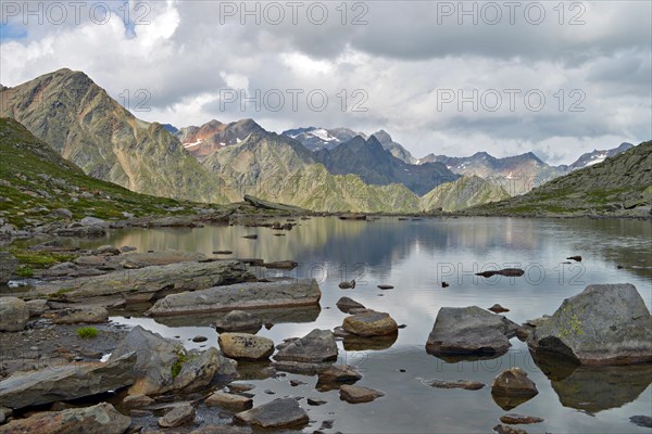 Mountain lake at Timmelsjoch looking towards the Stubai Alps