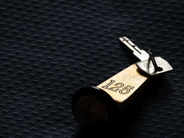 Hotel key lying on a hotel bed