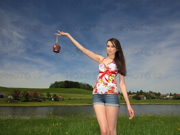Woman holding a cowbell from Allgaeu