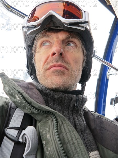 Skiers during a gondola ride in St. Anton am Arlberg