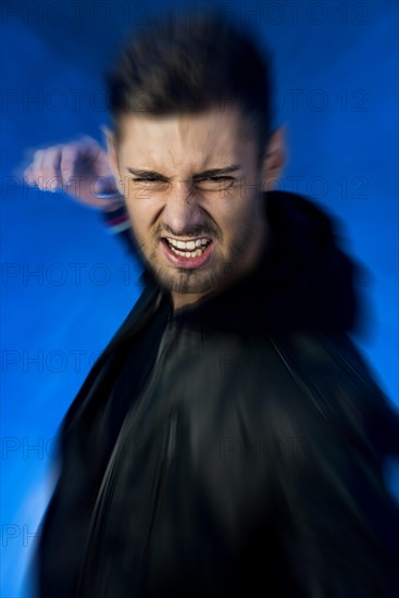 Aggressive young man with his hand prepared to strike