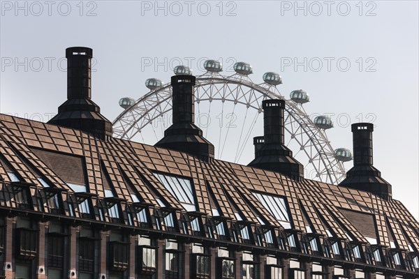 London Eye behind the roof of the Portcullis House