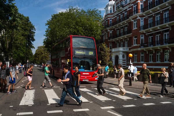 Tourists on the zebra crossing of the famous Beatles album cover