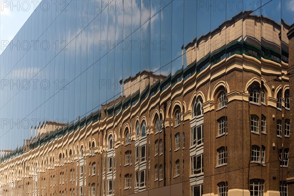 Reflection in a mirrored facade in Battle Bridge Lane