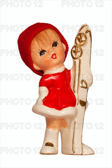 Porcelain doll with ski clothing and skis
