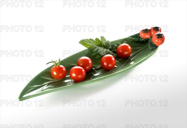 Cherry tomatoes in an elongated leaf-shaped bowl