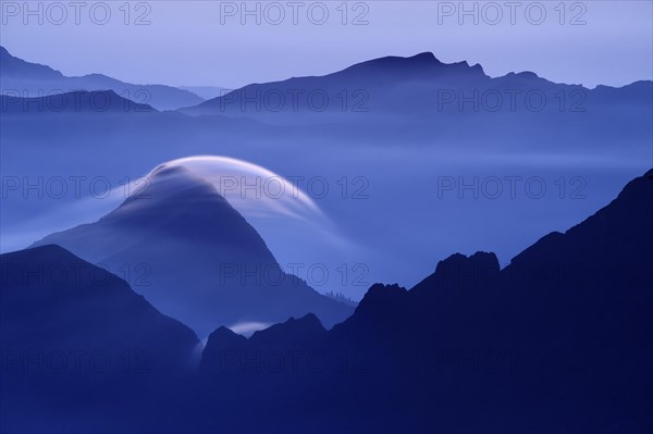 Peaks at the blue hour with rolling cloud