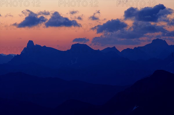 Mountain panorama in the evening light with clouds in the sky