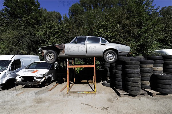 Wrecked cars and tyres in a junkyard