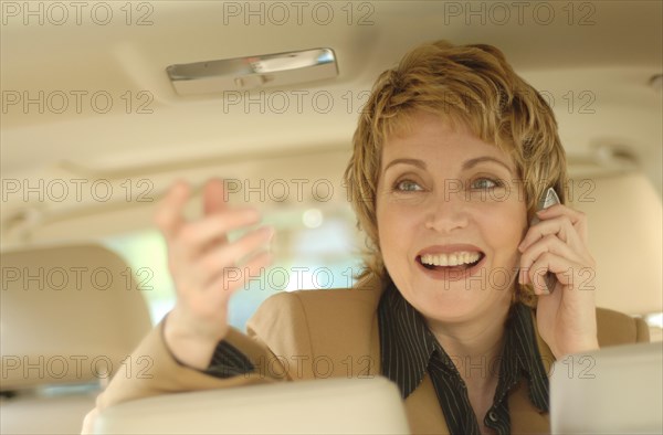 Businesswoman making a phone call in a car