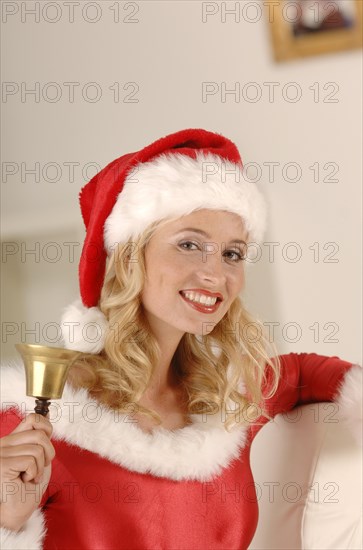 Sexy Miss Santa ringing a golden bell