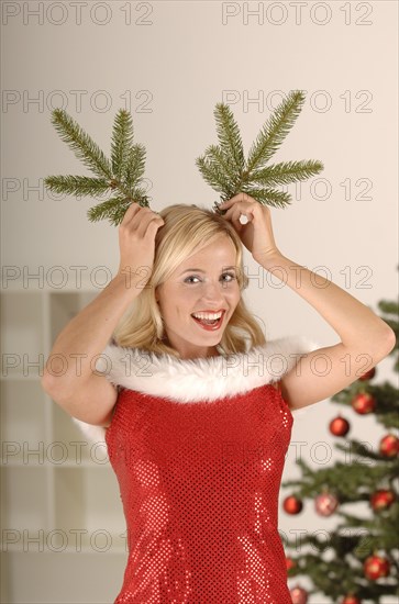 Sexy Miss Santa with pine branches as horns
