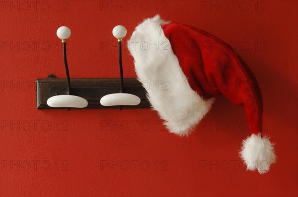 Santa Claus hat hanging on nostalgic coat hooks