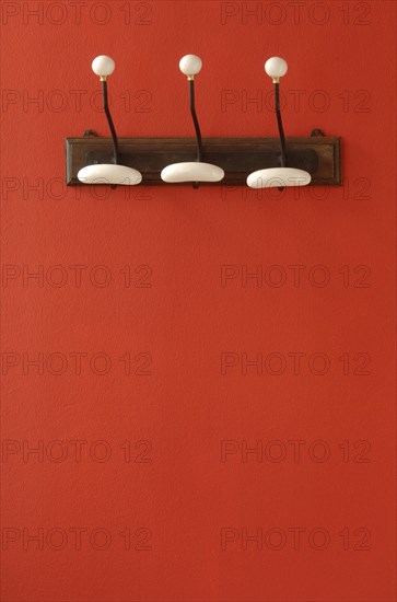 Nostalgic coat hooks on red wall